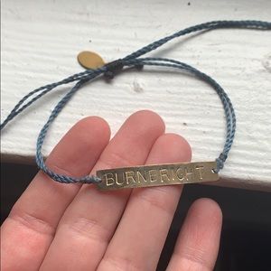 Gold plated bar bracelet with “Burn Bright” logo